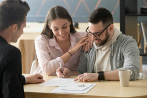 Couple signing documents for buying a home